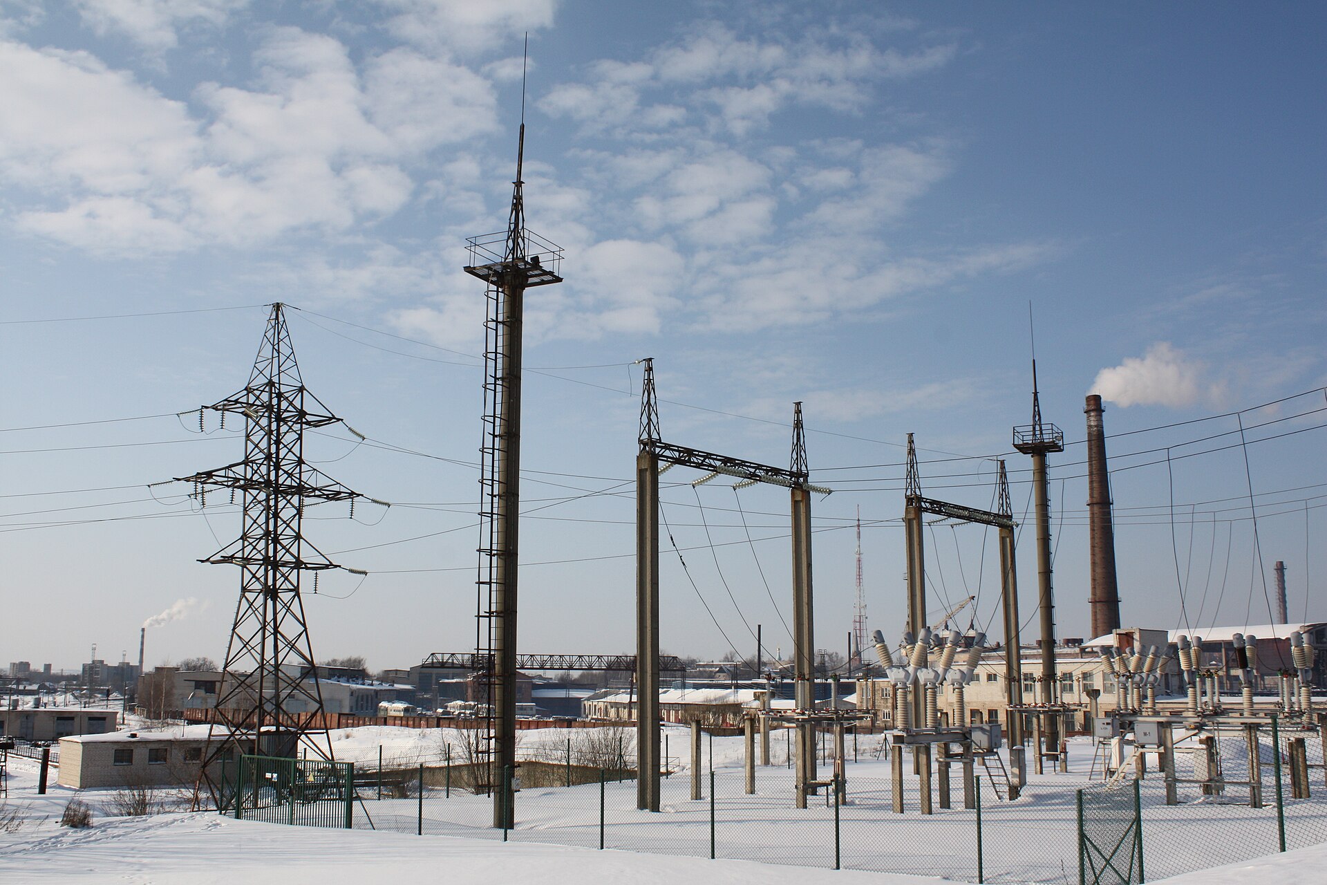 An outdoor substation with gantries and lightning masts